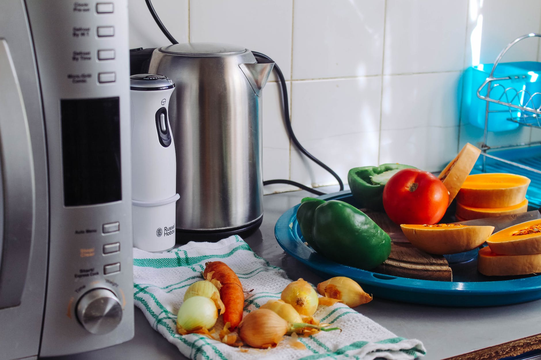 photo of vegetables beside gray electric kettle