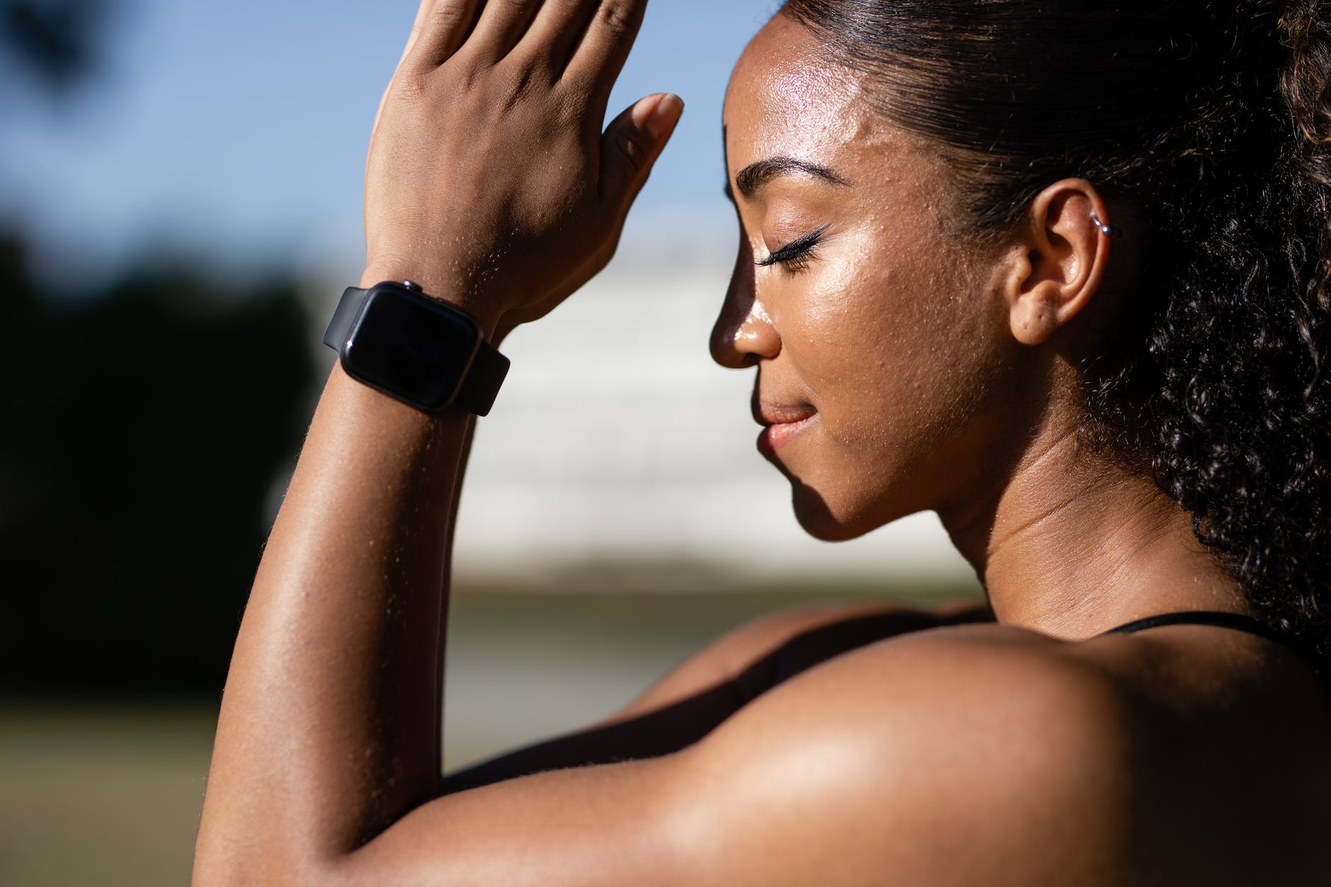 woman wearing black smartwatch meditating