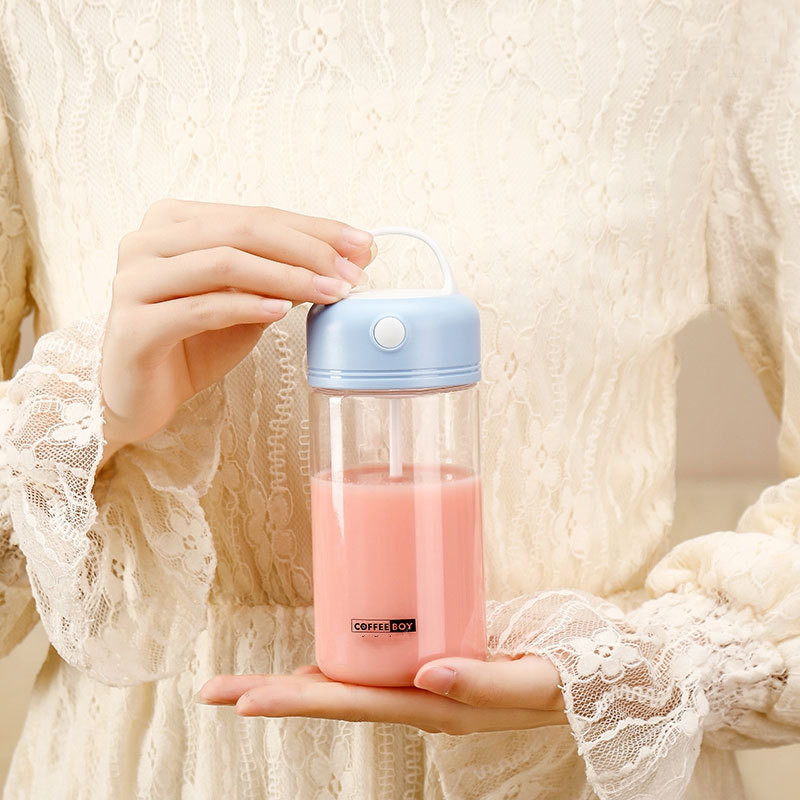 Blue 380ml electric protein shaker held in one hand