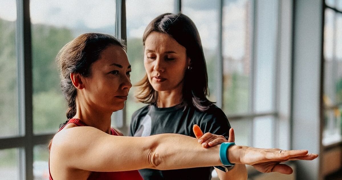 personal training gym session with a coach guiding one client