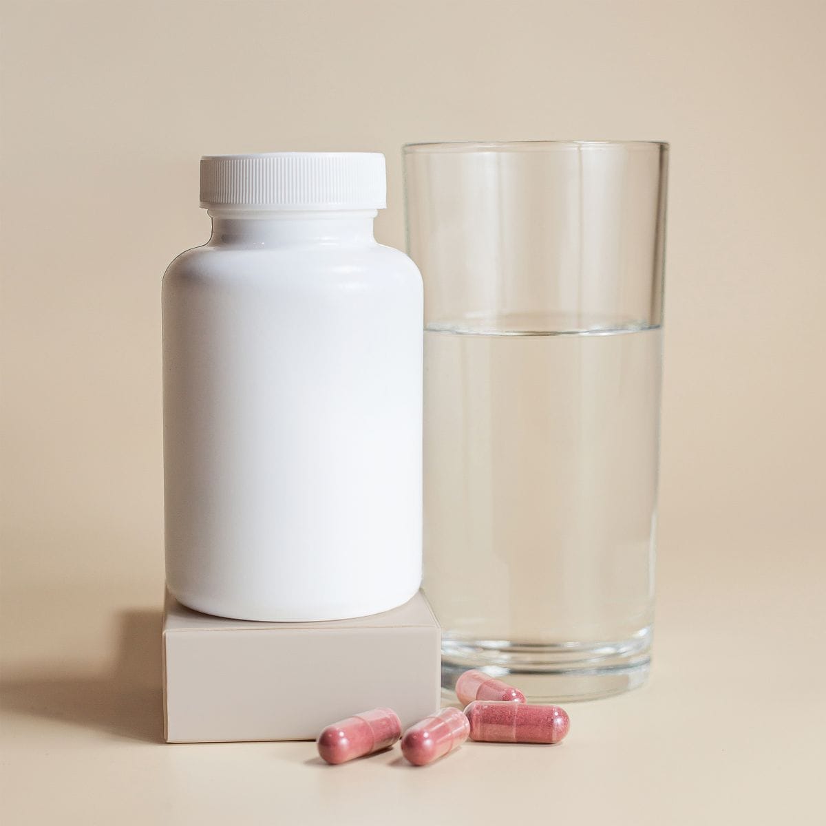 creatine supplement bottle with a glass of water