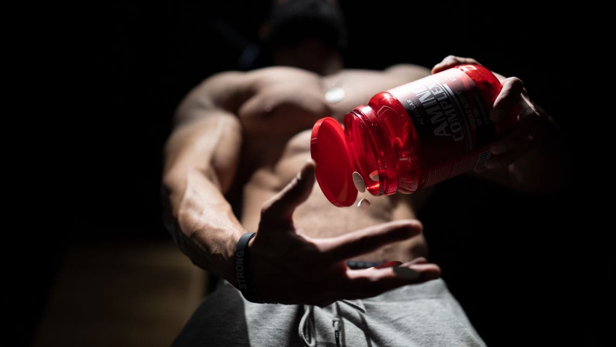 pouring protein powder supplement from a bottle