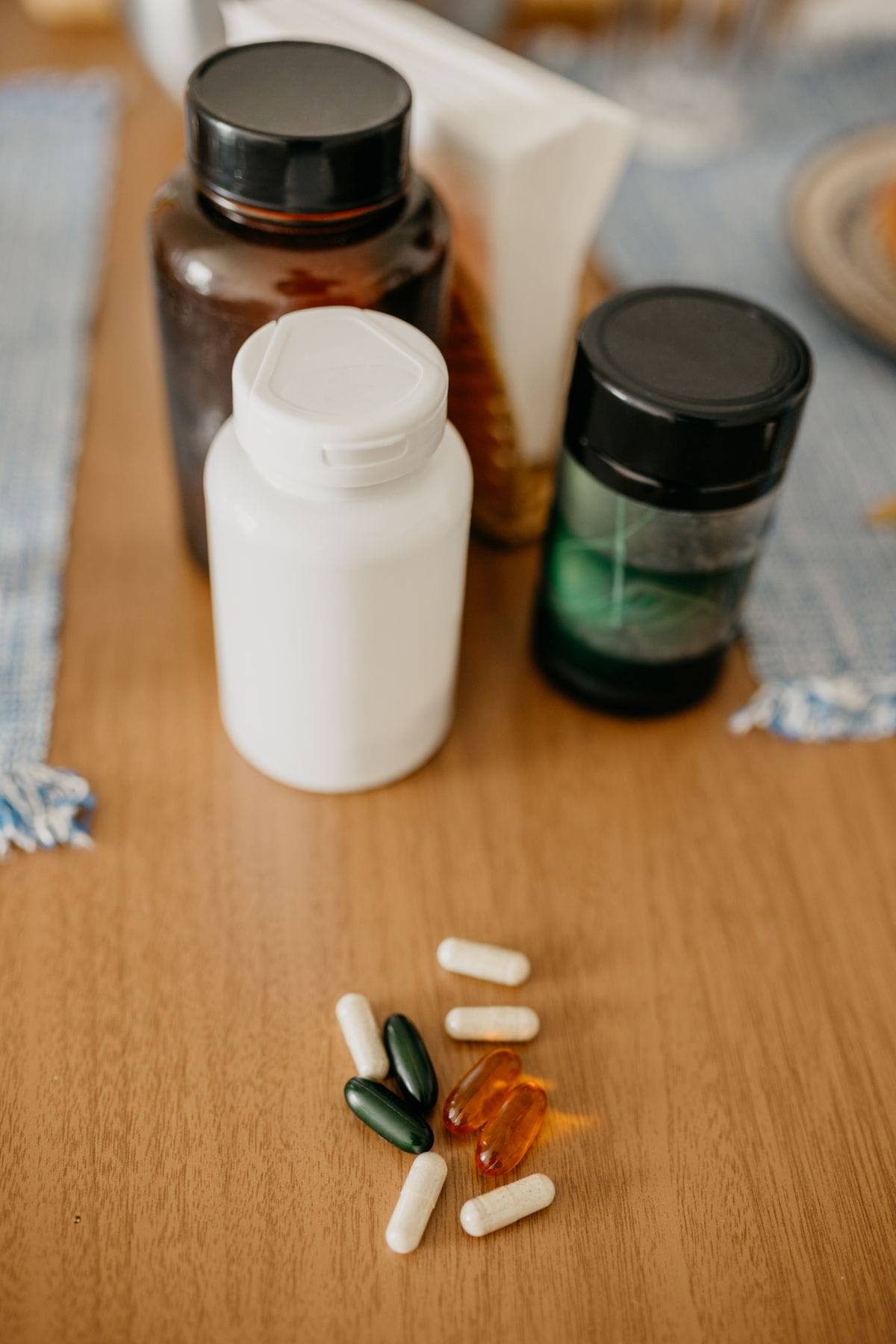creatine or protein supplement bottles on a wooden surface