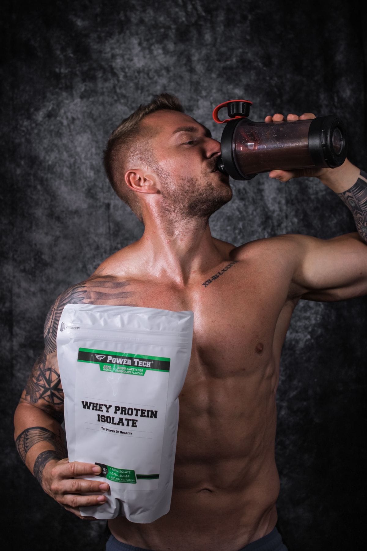 man drinking a protein shake with a whey protein bag