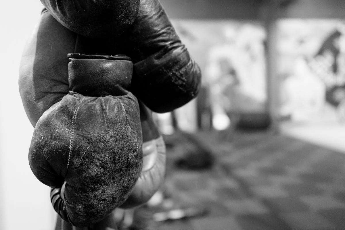Worn boxing gloves close-up — material and stitching detail
