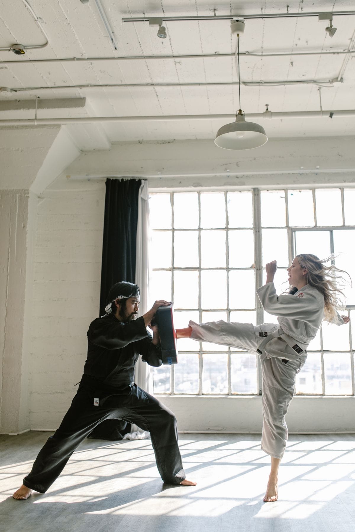 Group of martial artists practicing kicks in a thai boxing class